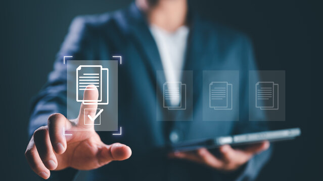 E-document management, online documentation database, paperless office concept, Businessman touching on document for online approve paperless quality assurance and ERP management concept.