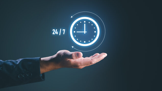 nonstop service concept. businessman hand holding virtual 24/7 with clock on hand for worldwide nonstop and full-time available contact of service concept. customer service.