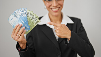 Young beautiful hispanic woman business worker pointing to chilean pesos smiling over isolated white background