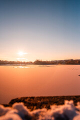 sunset over the iced lake 