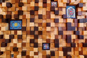 Decorative wooden panel made of cubes with colorful inserts of paintings