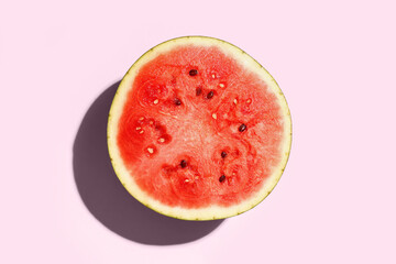 Half of fresh watermelon on pink background