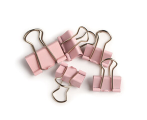 Pink binder clips on white background