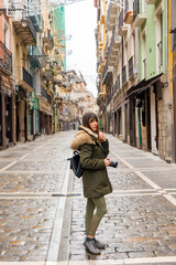 Brown-haired tourist explores Pamplona streets.