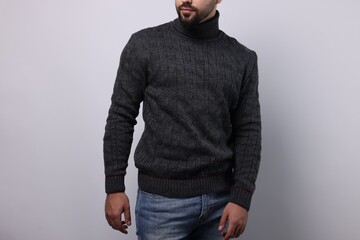 Man in stylish sweater on white background, closeup