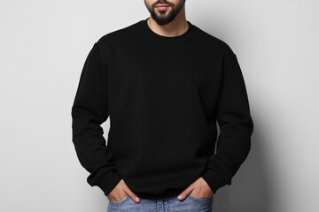 Man in stylish sweater on white background, closeup - Powered by Adobe
