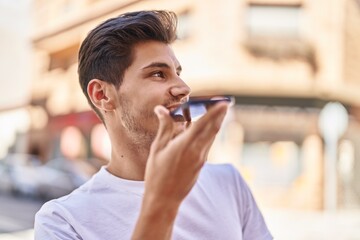 Young hispanic man smiling confident talking on the smartphone at park