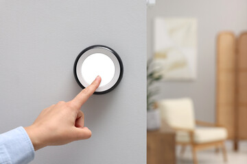 Fototapeta premium Woman adjusting thermostat on white wall indoors, closeup and space for text. Smart home system