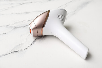 Modern photoepilator on grunge white background