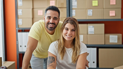 Man and woman ecommerce business workers working together smiling at office