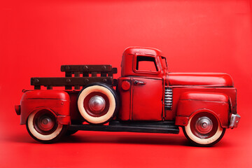 Vintage pickup truck from the 50s, Ford on a red background. toy or model.