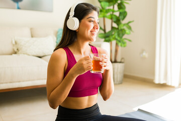 Relaxed woman doing yoga drinking healthy tea