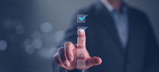 Business performance checklist, businessman using laptop doing online checklist survey, filling out...