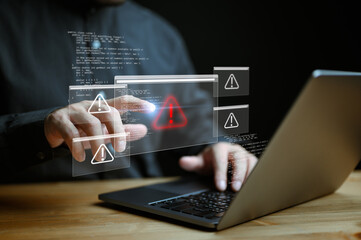 Businessman or it staffs, programmer, developer using computer laptop with triangle caution warning...