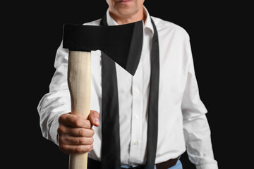 Man holding axe on black background
