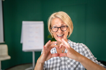 Portrait of one mature blonde caucasian woman with eyeglasses indoor