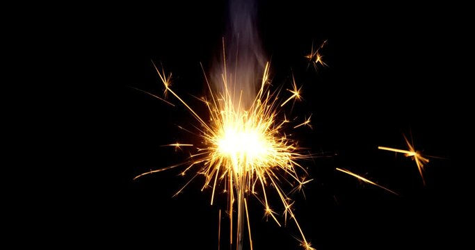Slow motion shot of sparklers burning on black background sparklers
