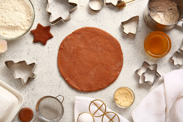 Fresh dough and ingredients for Christmas gingerbread cookies on grunge white background