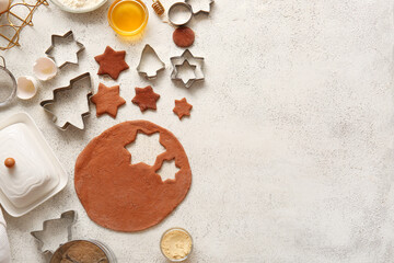 Fresh dough and ingredients for Christmas gingerbread cookies on grunge white background
