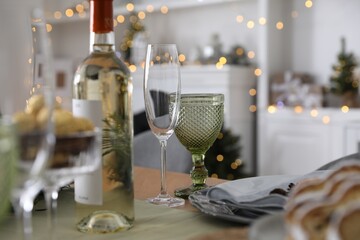 Christmas table setting with bottle of wine and dishware