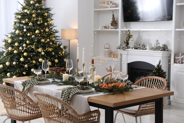 Christmas table setting with festive decor and dishware in living room