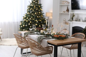 Christmas table setting with festive decor and dishware in living room