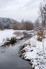 a stream in the snowy landscape, snow-covered landscape, winter fairytale landscape