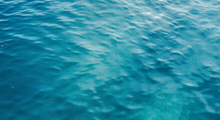 Overhead view of some ripples in a body of rather blue, seemingly deep water.