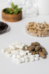 Fototapeta na wymiar Various vitamins, tablets and dietary supplements with natural formulations on a white background.