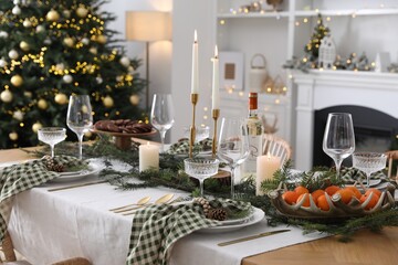 Christmas table setting with festive decor and dishware in living room