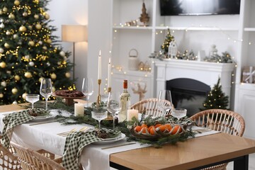 Christmas table setting with festive decor and dishware in living room