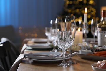 Christmas table setting with festive decor and dishware indoors