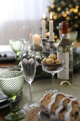 Christmas table setting with festive decor and glassware indoors