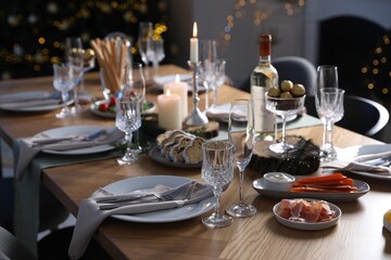 Christmas table setting with festive decor and dishware indoors