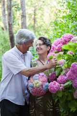 Summer Joy and Love in a Garden With Colorful Flowers for this Beautiful Senior Caucasian Couple Married For 40+ Years