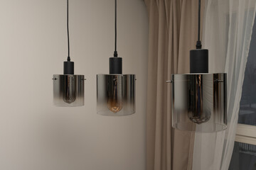 Three modern lamps. Three hanging lamps in the form of a cylinder with tinted glass.