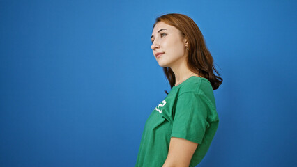 Young woman volunteer standing with serious face over isolated blue background