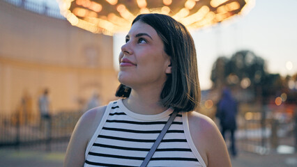 Young beautiful hispanic woman smiling looking around at Prater Vienna