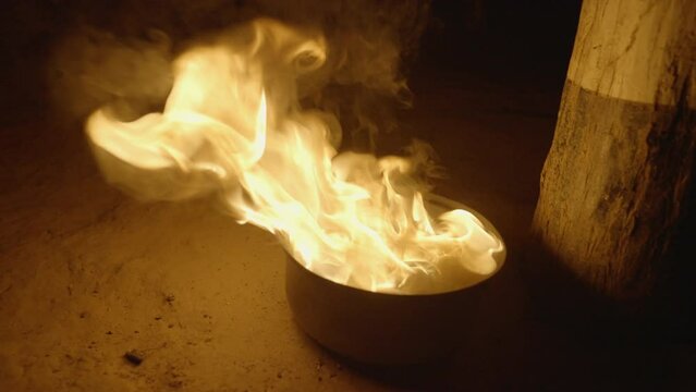 Panning Shot Of Fire Flames Glowing In Bowl By Wooden Pole At Night - Manaus , Brazil