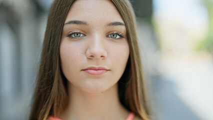 Obraz premium Young beautiful girl standing with serious expression at street