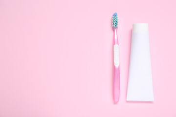 Toothbrush with toothpaste on color background.
