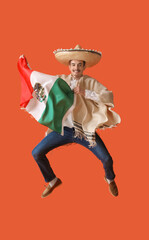 Handsome young man in poncho, sombrero and with flag of Mexico jumping on orange background