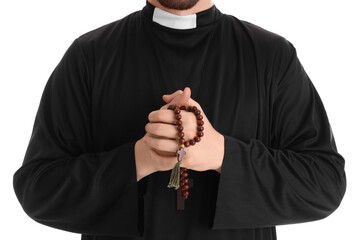 Young priest with praying beads on white background, closeup