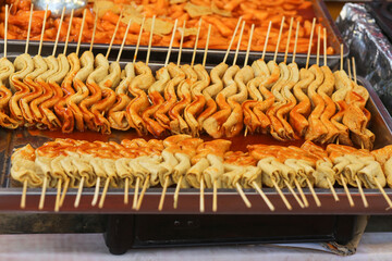 Explore the flavors of Ho Chi Minh City's street food with a close-up of a delicious fried cheese sausage