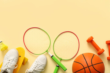 Set of sports equipment with shoes on color background