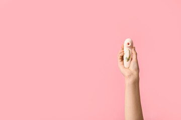 Female hand with vibrator on pink background - obrazy, fototapety, plakaty