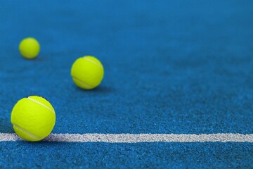 three yellow tennis  balls at sport court