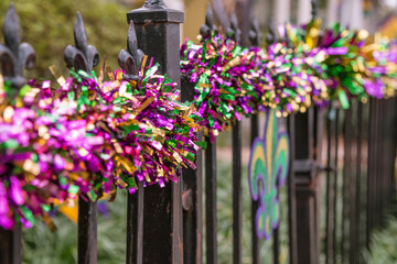 Mardi Gras decorations in the French Quarter in New Orleans in the colors of purple, gold and green. - obrazy, fototapety, plakaty