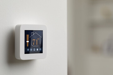 Thermostat displaying temperature in Fahrenheit scale and different icons. Smart home device on...