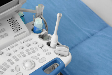 Ultrasound control panel and examination table in hospital, closeup